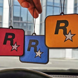 Custom branded square hanging FragranceAirFreshenerCard  in red, blue, and orange with minimalist star logo Giftshop