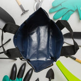 Blue and beige Heavy-Duty Multi-Pocket Oxford Tool Tote with black handles and multiple exterior pockets for garden tools. Gift Shop