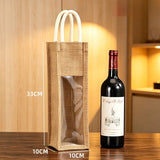 Natural Artisan Jute Wine Carrier with clear window and white rope handles on a wooden surface_Corporate Door Gift