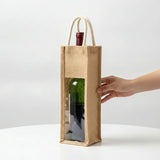 Natural Artisan Jute Wine Carrier with clear window and white rope handles on a wooden surface_Corporate Door Gift