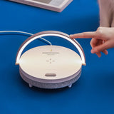 Hand interacting with a modern lamp on a blue background