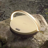 LED camping light on a rock with water in the background