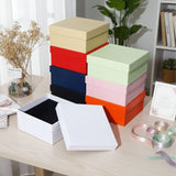 A colorful stack of premium Lift Off Lid Rigid Boxes in various shades including navy, red, orange, pink, and black, featuring a sturdy two-piece telescopic design for high-end gift packaging. corporate gift singapore