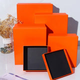 A colorful stack of premium Lift Off Lid Rigid Boxes in various shades including navy, red, orange, pink, and black, featuring a sturdy two-piece telescopic design for high-end gift packaging. corporate gift singapore