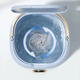 Open washing machine drum with clothes inside on a white background