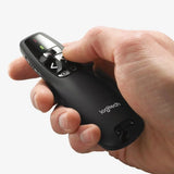 An Asian professional using the ergonomic Logitech R400 clicker to seamlessly present design concepts to her team in a collaborative workplace._Customised Premium Corporate Gift