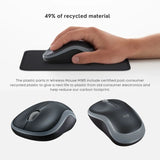 A user operating a black and gray Logitech M185 wireless mouse on a wooden desk next to a laptop with a plugged-in USB nano receiver_customised Corporate gift Singapore