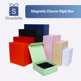 A collection of premium Magnetic Closure Rigid Boxes in various sizes and colors, including black, red, navy, pink, and lime green, featuring a seamless flip-top lid with a concealed magnetic seal. corporate gift