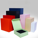 A collection of premium Magnetic Closure Rigid Boxes in various sizes and colors, including black, red, navy, pink, and lime green, featuring a seamless flip-top lid with a concealed magnetic seal. corporate gift