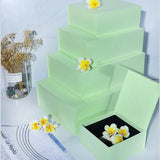 A collection of premium Magnetic Closure Rigid Boxes in various sizes and colors, including black, red, navy, pink, and lime green, featuring a seamless flip-top lid with a concealed magnetic seal. corporate gift