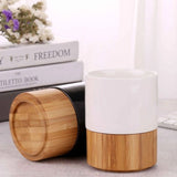 Minimalist black and white ceramic mugs with natural bamboo bases_ corporate gift