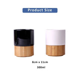Minimalist black and white ceramic mugs with natural bamboo bases_ corporate gift