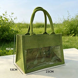 Natural jute tote bag with a clear PVC display window and padded handles on a grassy background_corporate jute bag_corporate door gift