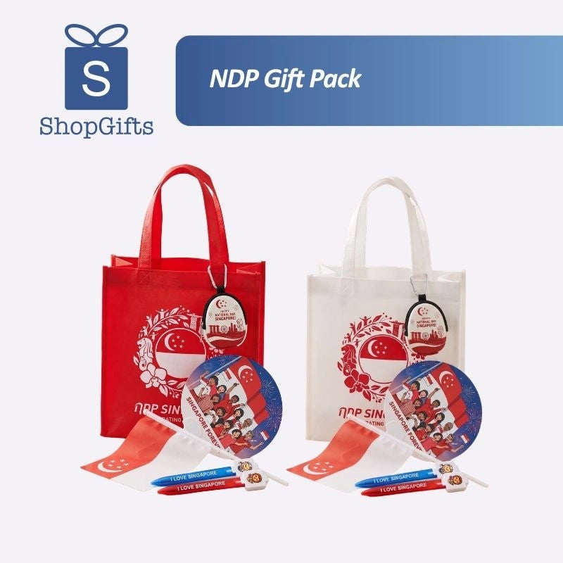 Custom Singapore NDP Celebration gift pack featuring a branded eco-friendly white tote bag, red Merlion hand fan, patriotic coin pouch, handheld flag, and custom pens for corporate gifting_Promotional Corporate Gifts