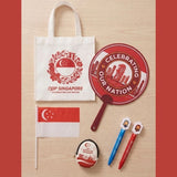 Custom Singapore NDP Celebration gift pack featuring a branded eco-friendly white tote bag, red Merlion hand fan, patriotic coin pouch, handheld flag, and custom pens for corporate gifting_Promotional Corporate Gifts