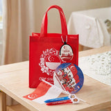 Custom Singapore NDP Celebration gift pack featuring a branded eco-friendly white tote bag, red Merlion hand fan, patriotic coin pouch, handheld flag, and custom pens for corporate gifting_Promotional Corporate Gifts
