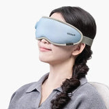 Person wearing a light blue sleep mask with a white background