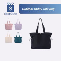Black tote bag with other color options on a white background, featuring ShopGifts logo.