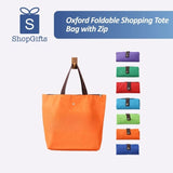 Vibrant orange Premium Foldable Oxford Waterproof Tote Bag hanging on a wooden hook with folded color options_ customised corporate gift singapore