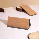 folded Portable Cork 3-in-1 Wireless Charger on table with some wooden decoration