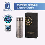 Premium Titanium Thermos Bottle with packaging and branding elements on a white background
