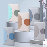 Three Minimalist Two-Tone Premium Business Journals in blue and grey shades with circular magnetic clasps_ corporate gift