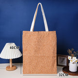 Cork tote bag with measurements against a blue wall