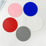 Minimalist food-grade silicone anti-slip coaster with raised edge for heat protection and spill containment_ corporate gift