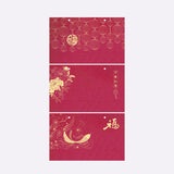 Red envelope with gold floral and fish design on a white background