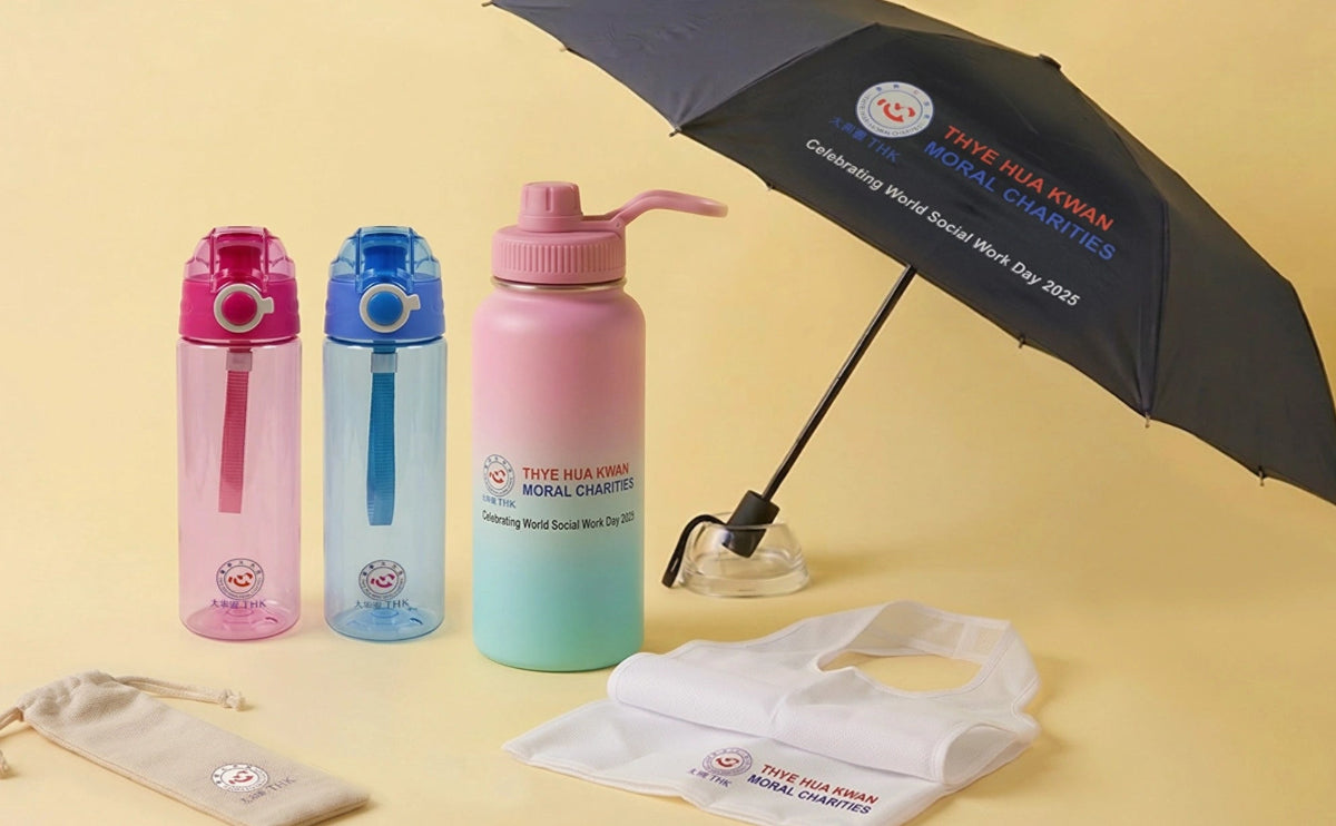 Three water bottles with colorful caps, a black umbrella, and a white bag on a yellow background.