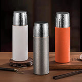 Titanium Thermal Brew Mug on a wooden surface with a dark background