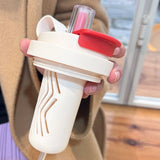 Matte black and cream Triple-Mode 316 Stainless Steel Tumblers with dual-drinking lids on a white background