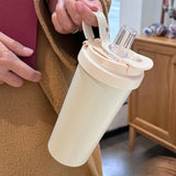 Matte black and cream Triple-Mode 316 Stainless Steel Tumblers with dual-drinking lids on a white background