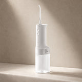 Xiaomi 200ml Cordless Water Flosser (MEO705) in white with clear ribbed tank on a bathroom counter