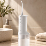 Xiaomi 200ml Cordless Water Flosser (MEO705) in white with clear ribbed tank on a bathroom counter