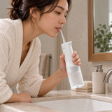 Xiaomi 200ml Cordless Water Flosser (MEO705) in white with clear ribbed tank on a bathroom counter