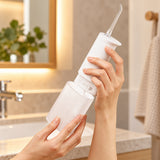 Xiaomi 200ml Cordless Water Flosser (MEO705) in white with clear ribbed tank on a bathroom counter