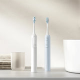 White and light blue Precision Oscillation Smart Sonic Electric Toothbrush on a minimalist bathroom counter_Premium corporate gift