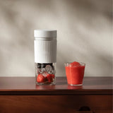 Xiaomi 300ml Portable Blender  with a transparent cup and silicone sleeve for smoothies.