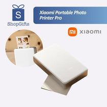 Xiaomi Portable Photo Printer Pro (KDRSHDY03HT) in white beside printed snapshots.
