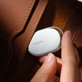 Sleek white Xiaomi Smart Tag Precision Bluetooth Tracker with silver trim attached to a keyring on a white surface_Premium Corproate Gifts Idea