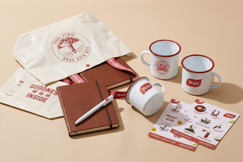 Yeo's branded mugs, notebooks, and promotional material on a beige background
