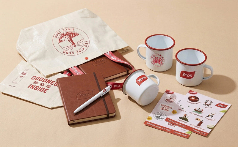 Yeo's branded mugs, notebooks, and promotional material on a beige background