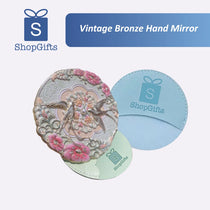 Vintage bronze hand mirror with floral design on a white background, featuring ShopGifts branding.