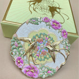 Decorative mirror  with birds and floral design on a beige background